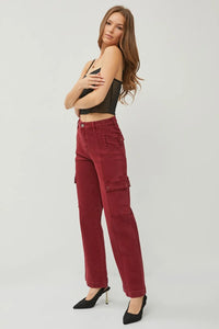 Woman wearing red cargo pants on a white background