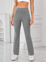 Person wearing gray pants in a minimalistic setting