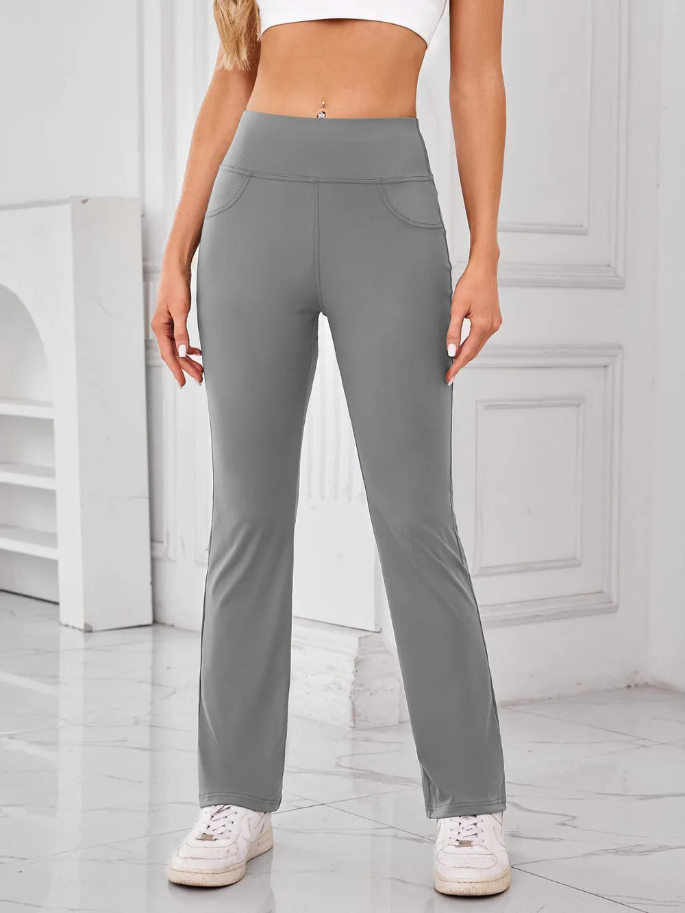 Person wearing gray pants in a minimalistic setting