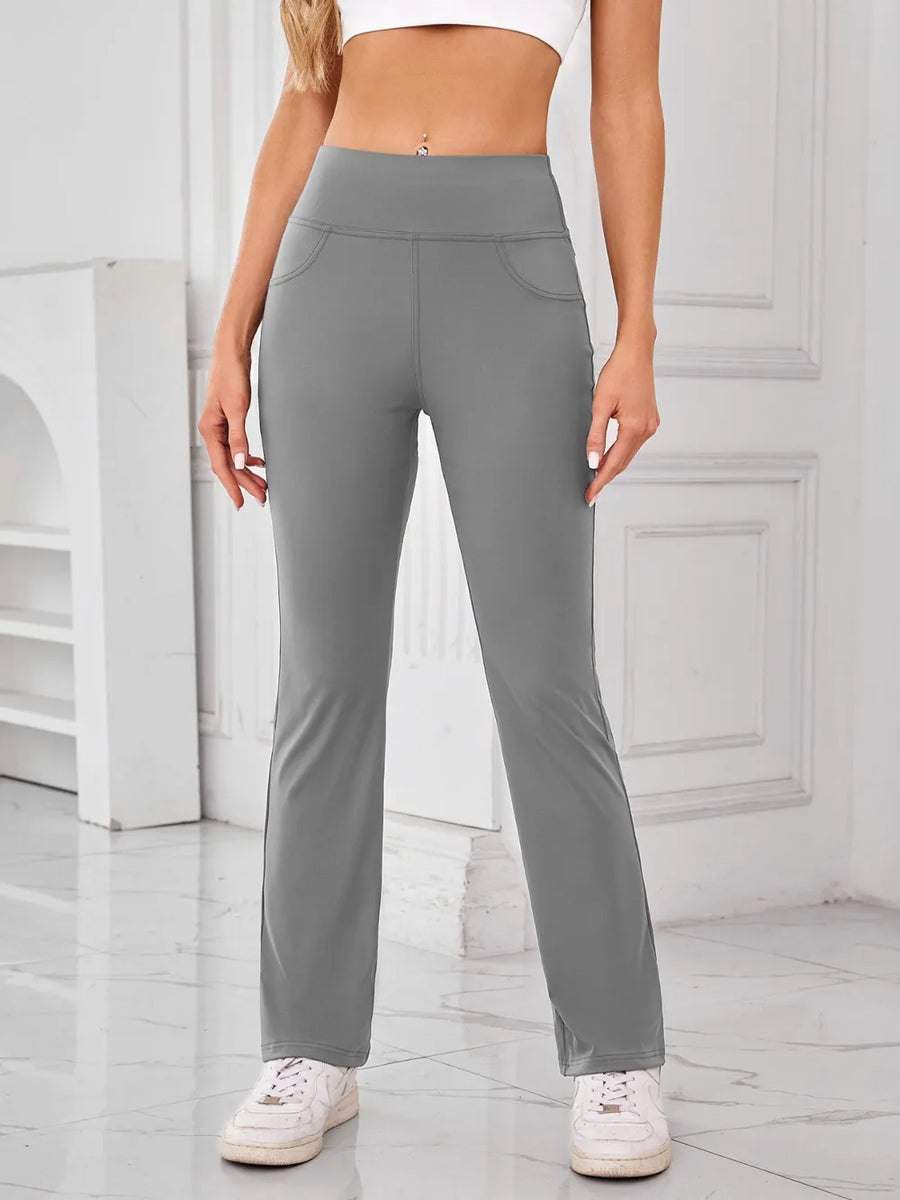 Person wearing gray pants in a minimalistic setting