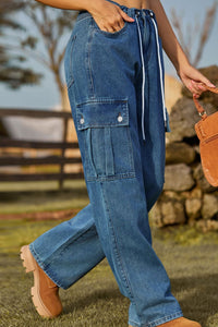 Person wearing blue cargo pants with a blurred background