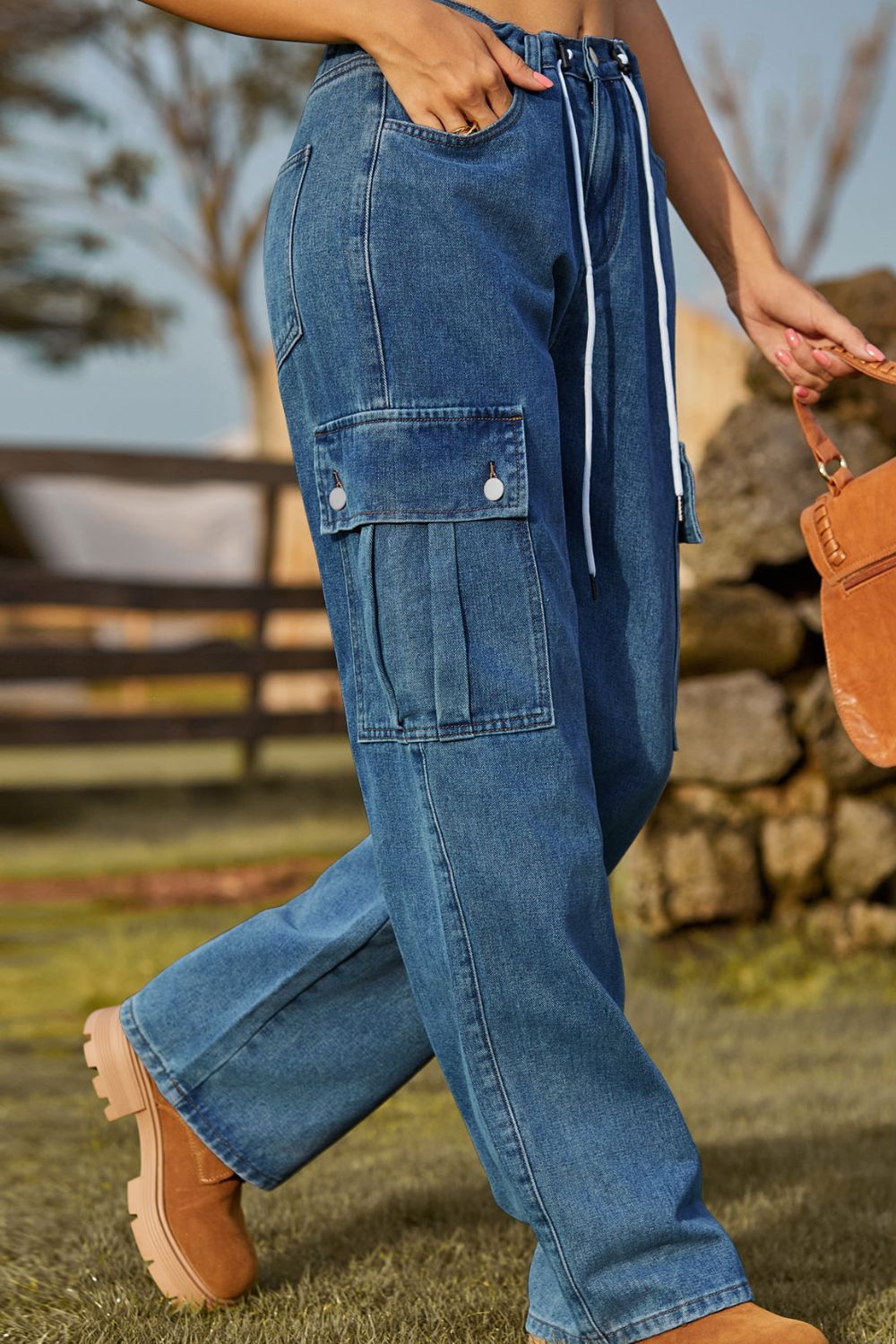 Person wearing blue cargo pants with a blurred background