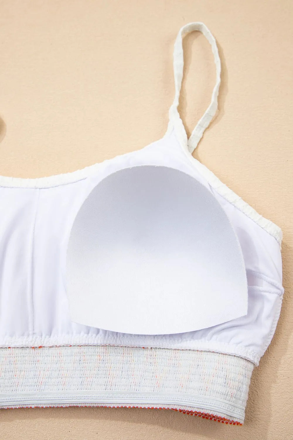 White bra on a beige background