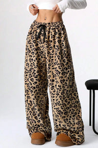 Leopard print pants worn by a person on a white background