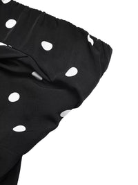 Black fabric with white polka dots on a white background