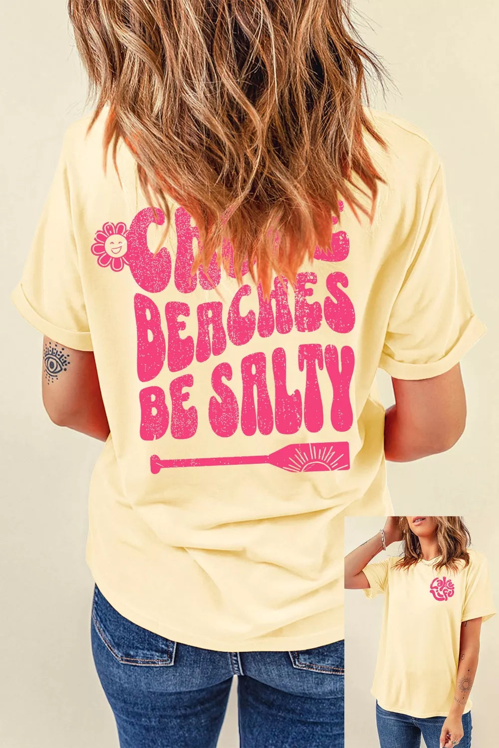 Person wearing a yellow t-shirt with pink text and graphics, standing against a neutral background.