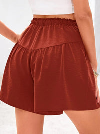 Person wearing a rust-colored skirt on a white background