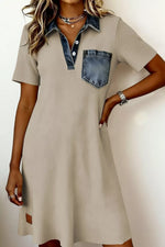 Beige dress with denim accents worn by a model on a plain background