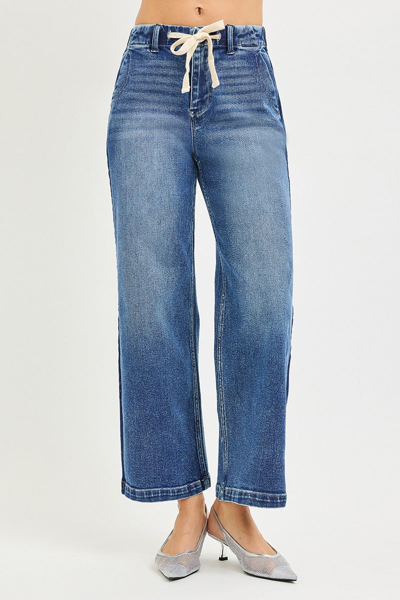 Blue jeans with a tie waist on a white background