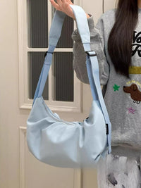 Young girl holding up a blue Adjustable Strap Crossbody Bag Purse