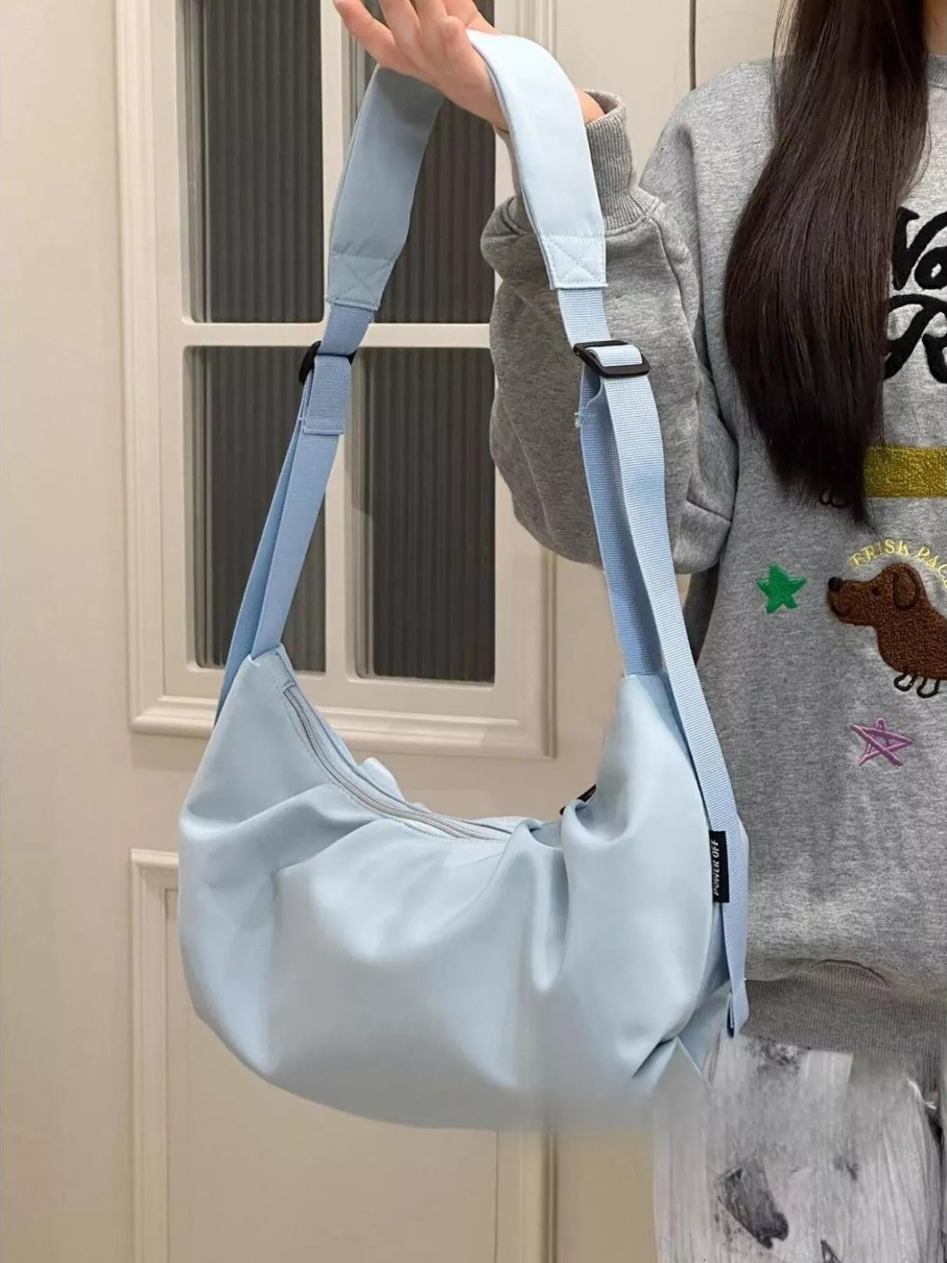 Young girl holding up a blue Adjustable Strap Crossbody Bag Purse