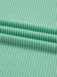 Close-up of green fabric with a subtle pattern