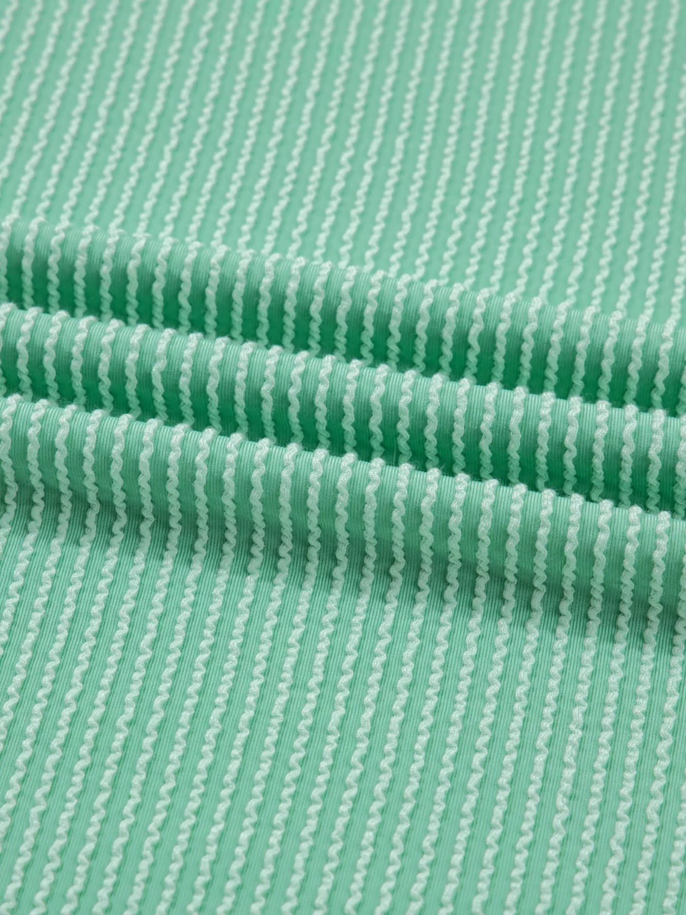 Close-up of green fabric with a subtle pattern