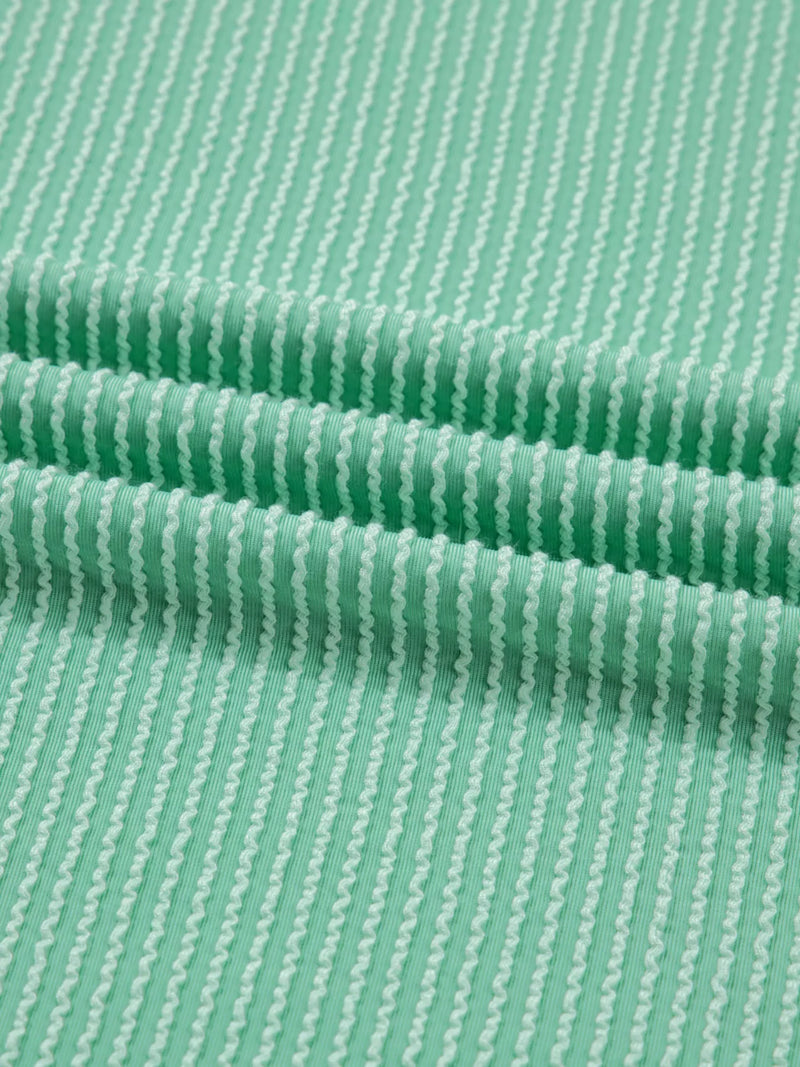 Close-up of green fabric with a subtle pattern