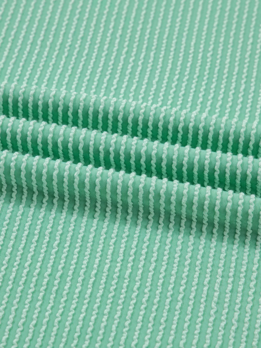 Close-up of green fabric with a subtle pattern