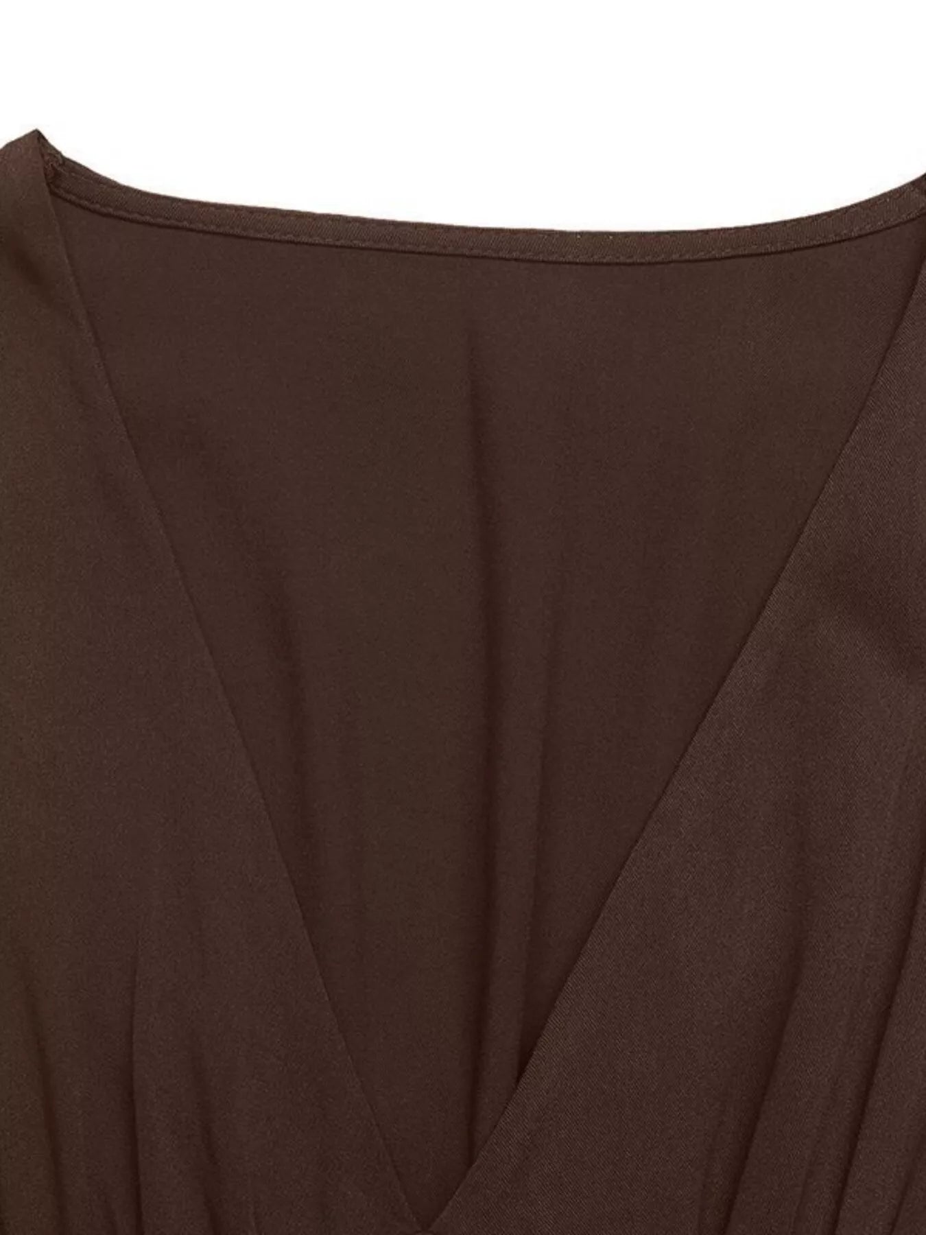 Close-up of a brown garment with a deep neckline on a white background