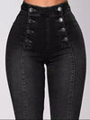 Black high-waisted jeans with button details on a gray background