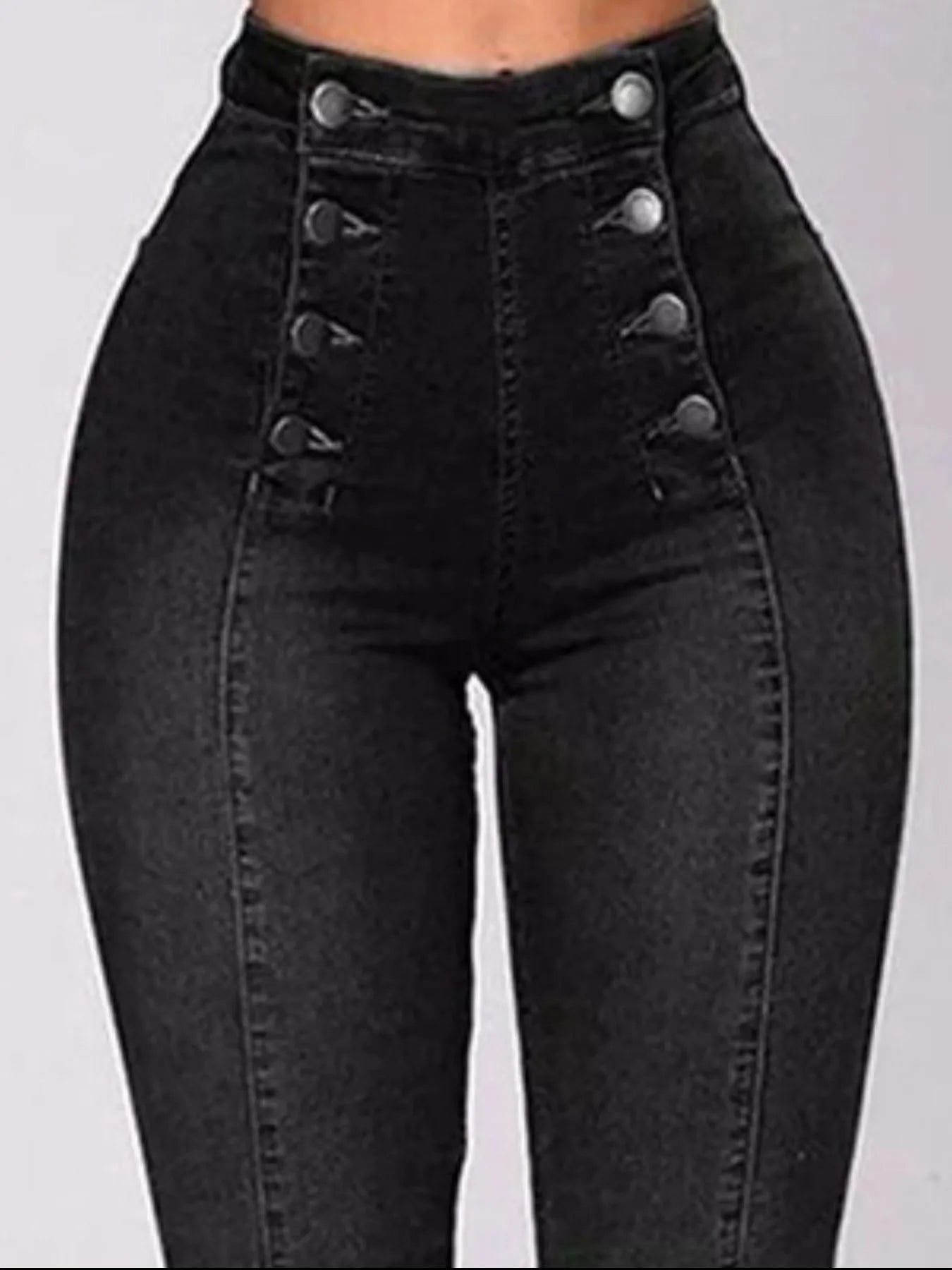 Black high-waisted jeans with button details on a gray background