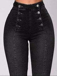 Black high-waisted jeans with button details on a gray background