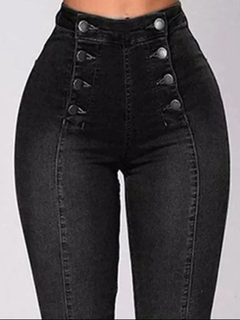 Black high-waisted jeans with button details on a gray background