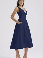 Navy blue dress worn by a model on a white background