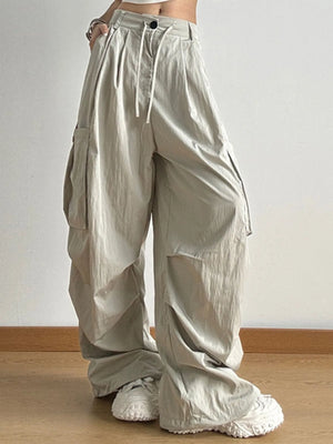 Beige wide-leg pants worn by a person on a plain background