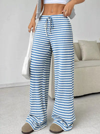 Person wearing blue and white striped pants in a living room setting