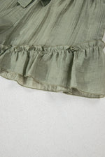 Green ruffled fabric on a white background