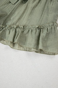 Green ruffled fabric on a white background