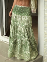 Green patterned skirt worn by a person standing near a door.