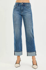 Blue jeans worn by a person on a white background