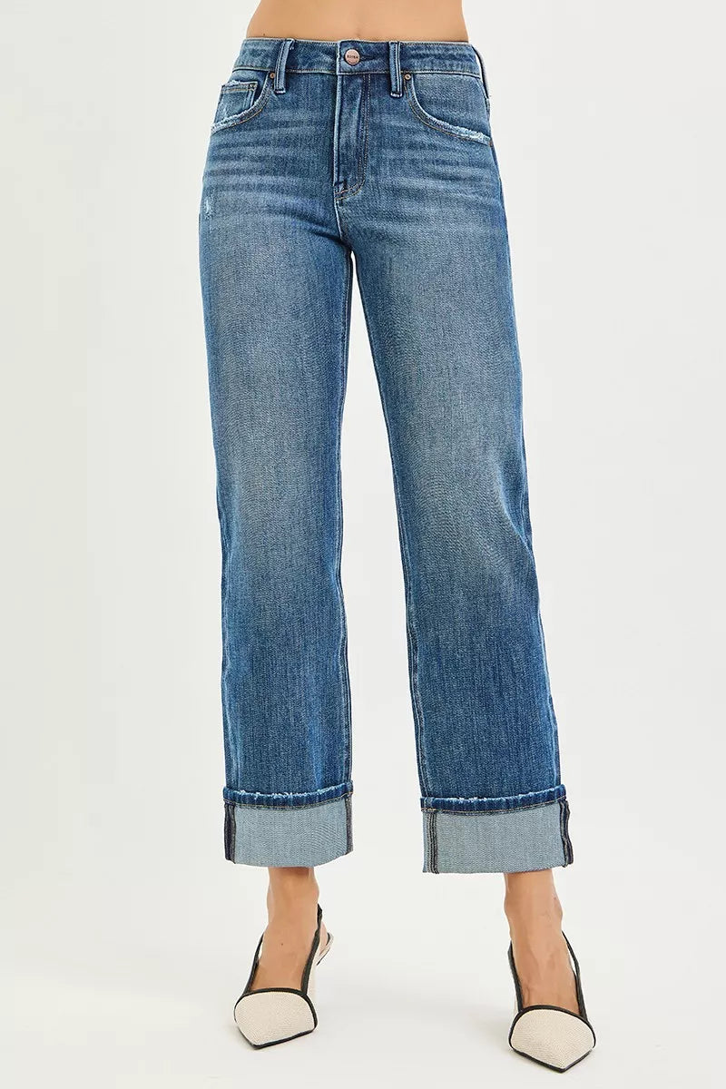 Blue jeans worn by a person on a white background