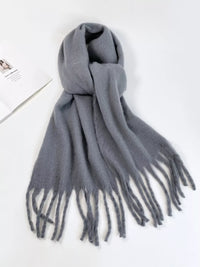 Gray scarf with tassels on a white background