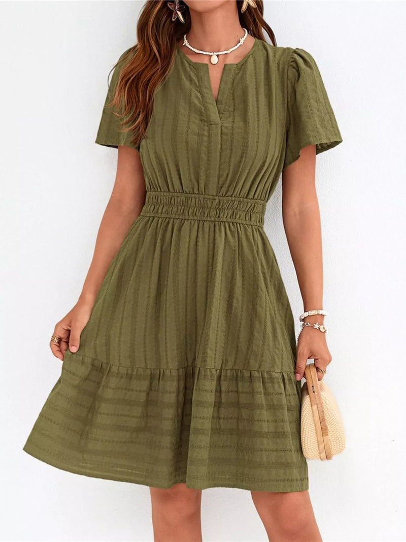 Woman wearing a green dress against a white background