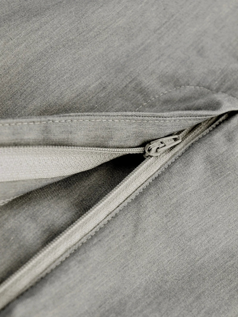 Close-up of a zipper on a gray fabric surface