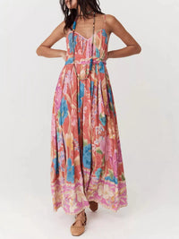 Woman wearing a colorful floral dress on a white background