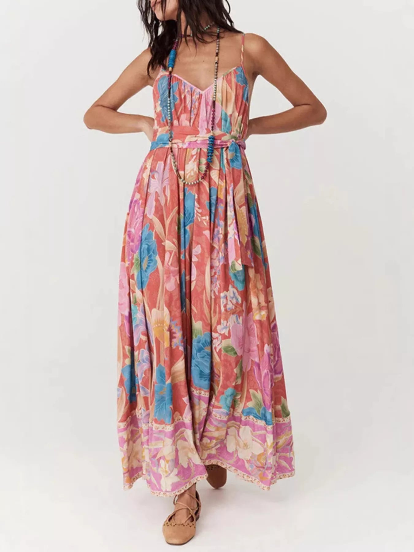 Woman wearing a colorful floral dress on a white background