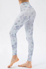 Light blue floral patterned leggings on a white background