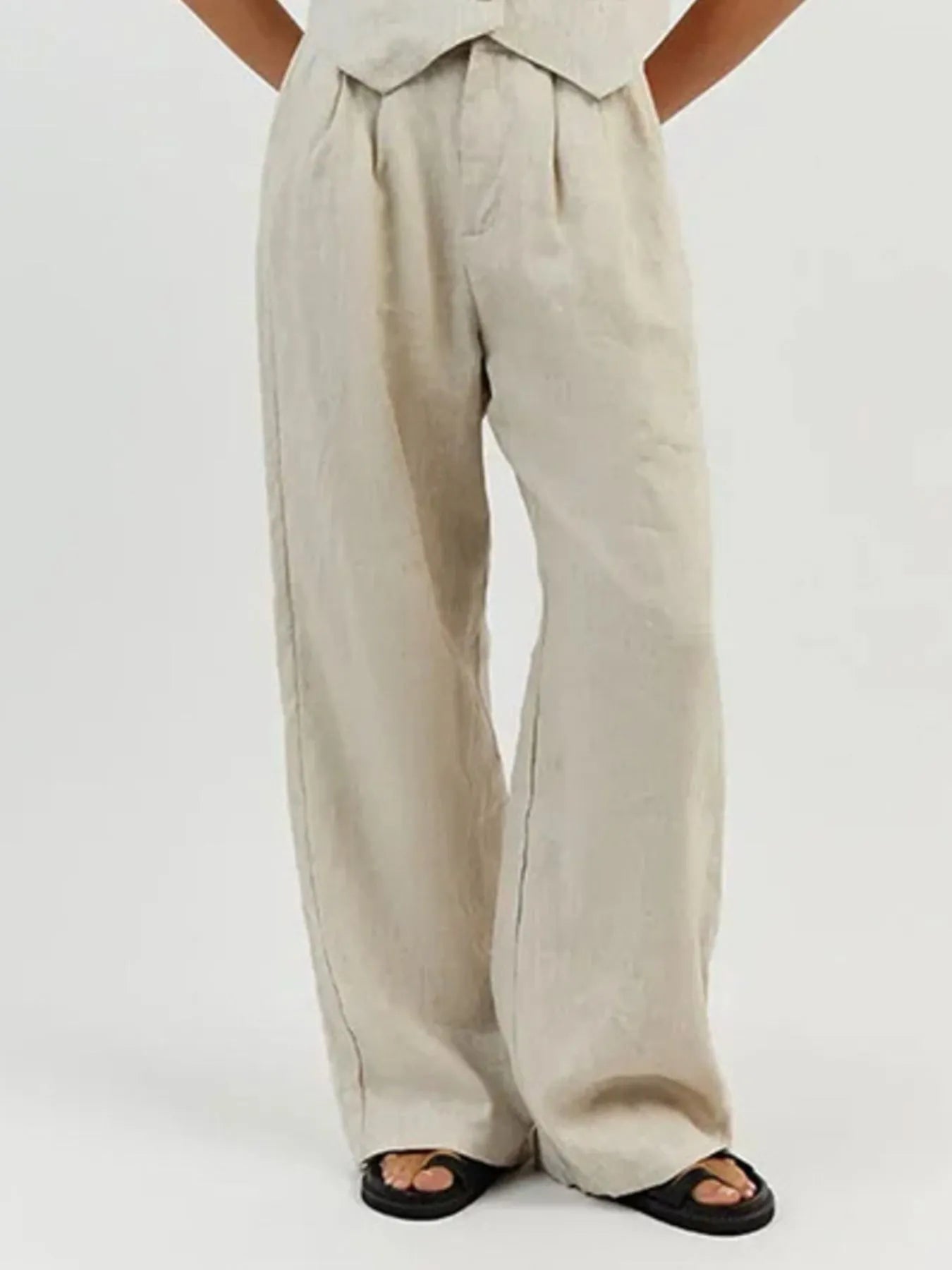 Beige wide-leg pants worn by a person on a white background
