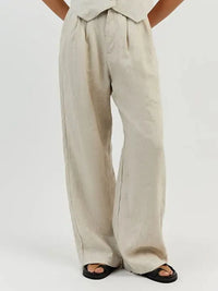 Beige wide-leg pants worn by a person on a white background