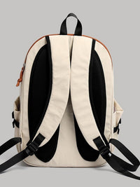 Beige backpack with black straps on a gray background