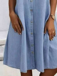 Light blue denim dress worn by a person with a neutral background