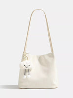 White shoulder bag with a smiley face design on a white background