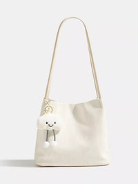 White shoulder bag with a smiley face design on a white background