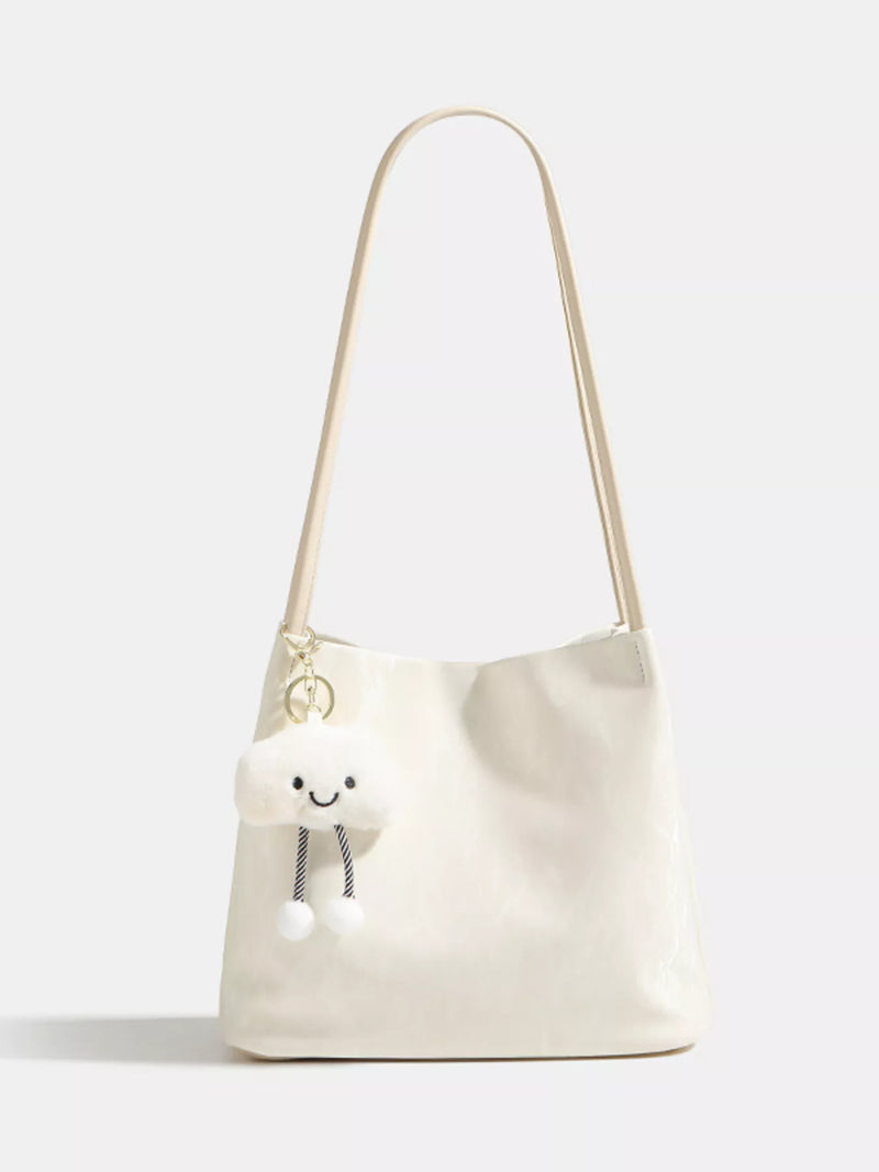 White shoulder bag with a smiley face design on a white background