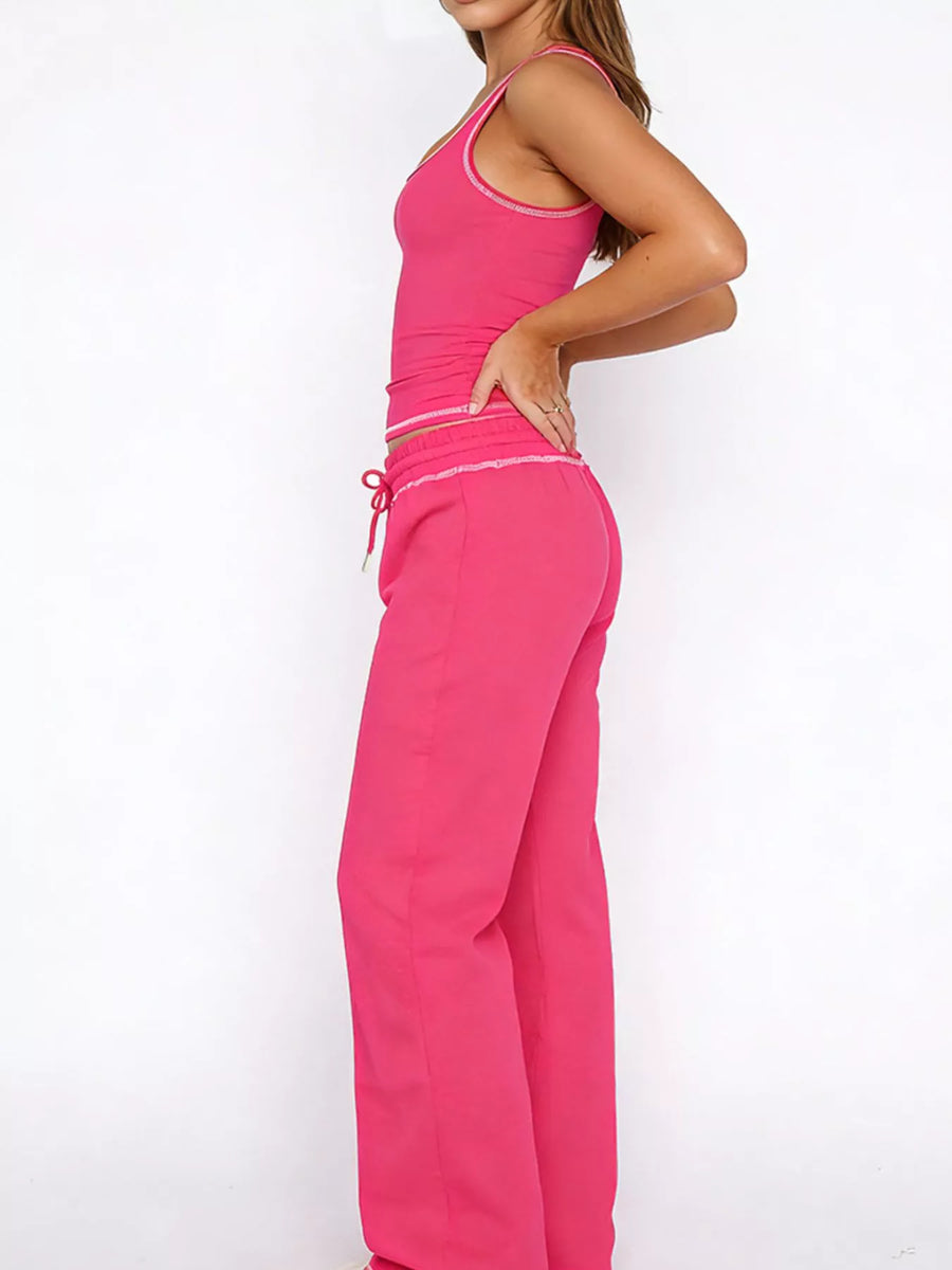 Person wearing a bright pink outfit on a white background
