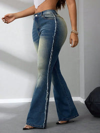 Person wearing blue flared jeans on a plain background
