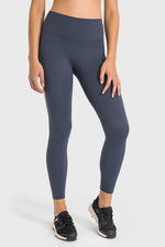 Person wearing dark gray leggings on a white background