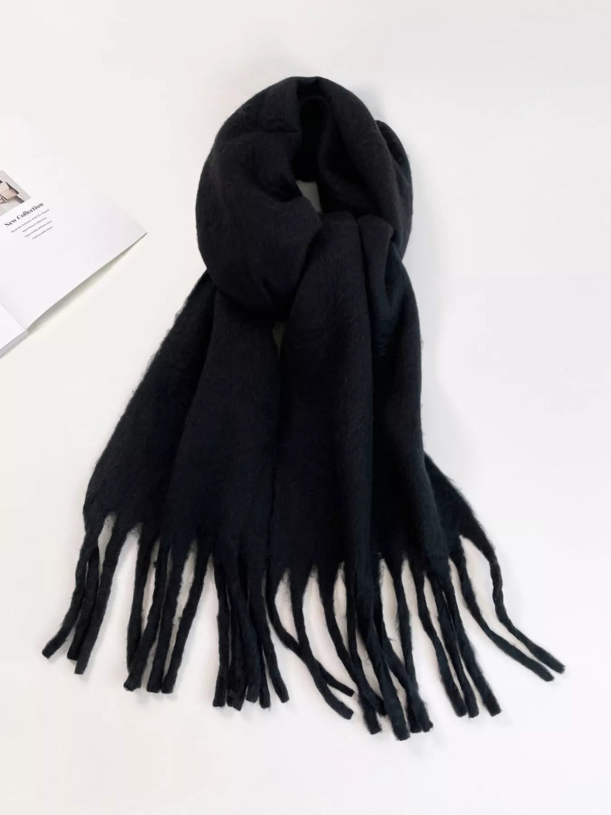 Black scarf with tassels on a white background