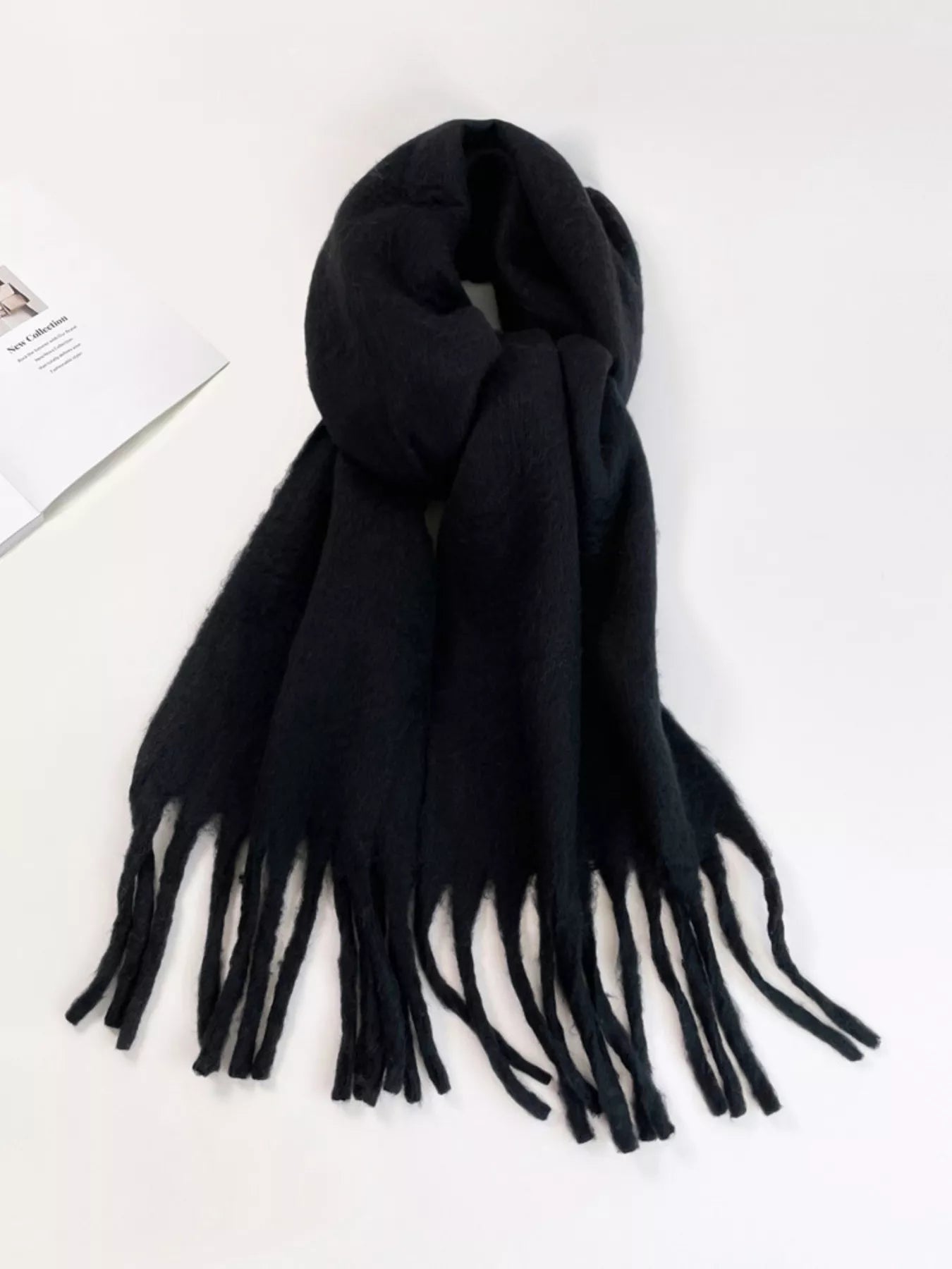 Black scarf with tassels on a white background